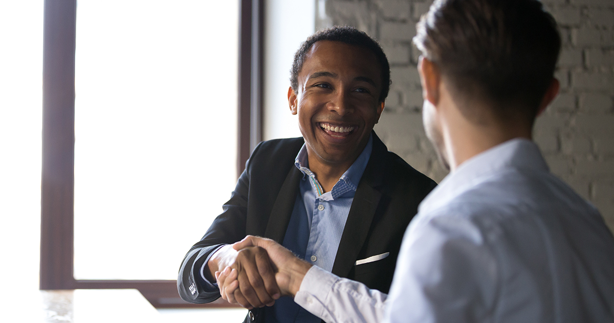 Satisfied black client shaking hands thanking manager for good d
