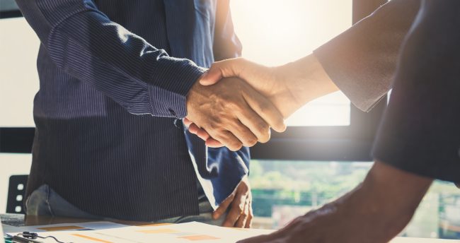 Retired couple talking with agent about contract agreement